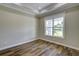 Inviting bedroom with hardwood floors, large window, and tray ceiling adding architectural interest at 324 3Rd N Ave, Safety Harbor, FL 34695