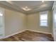 A bedroom with hardwood floors, a tray ceiling, and recessed lighting at 324 3Rd N Ave, Safety Harbor, FL 34695