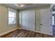 Bedroom with hardwood floors, a closet, and white trim at 324 3Rd N Ave, Safety Harbor, FL 34695