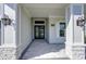 Welcoming entryway with stone pillars, stylish lanterns, and a view through double doors at 324 3Rd N Ave, Safety Harbor, FL 34695