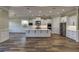 Open concept kitchen with white cabinetry, stainless steel appliances, and hardwood floors at 324 3Rd N Ave, Safety Harbor, FL 34695