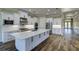 Stylish kitchen with a large island, white cabinets, and stainless steel appliances at 324 3Rd N Ave, Safety Harbor, FL 34695