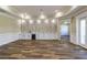 Open-concept living space featuring a wine bar, custom shelving, and warm hardwood flooring at 324 3Rd N Ave, Safety Harbor, FL 34695