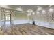 Open living room with hardwood floors, white cabinets, stone accent wall, and plenty of natural light at 324 3Rd N Ave, Safety Harbor, FL 34695