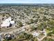 Wide aerial view showing homes, mature landscaping, and the overall neighborhood layout and nearby buildings at 3404 33Rd Street W Ct, Bradenton, FL 34205