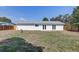 Fenced backyard with a large lawn and mature trees at 3404 33Rd Street W Ct, Bradenton, FL 34205