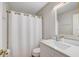 Bathroom featuring shower with white curtain, white vanity, gold fixtures and decorative mirror at 3404 33Rd Street W Ct, Bradenton, FL 34205