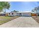 Front exterior of a home with mature trees and a long driveway at 3404 33Rd Street W Ct, Bradenton, FL 34205