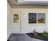 Inviting front entrance with a decorative glass door, modern lighting fixture, and freshly landscaped garden bed at 3404 33Rd Street W Ct, Bradenton, FL 34205