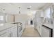 Bright kitchen featuring white cabinets, stainless steel appliances, and a large center island with modern light fixtures at 3404 33Rd Street W Ct, Bradenton, FL 34205