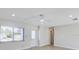 Bright living room featuring new laminate flooring, modern ceiling fan, and a view of the front yard at 3404 33Rd Street W Ct, Bradenton, FL 34205