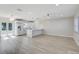 Open-concept living space with laminate flooring, modern lighting, and ample room for entertaining at 3404 33Rd Street W Ct, Bradenton, FL 34205