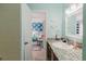 Bathroom with granite countertop, view of a bedroom with blue wallpaper and two beds at 3675 41St S Way # K, St Petersburg, FL 33711