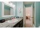 Bathroom with granite countertop and vanity, view of the botanical wallpaper of the bedroom at 3675 41St S Way # K, St Petersburg, FL 33711