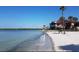 Picturesque beach with calm, clear water, and a row of condos surrounded by palms, offering a serene getaway at 3675 41St S Way # K, St Petersburg, FL 33711