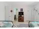 Charming bedroom featuring two beds, nautical decor, wood-look flooring, and access to an ensuite bathroom at 3675 41St S Way # K, St Petersburg, FL 33711