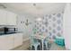 Eat-in dining area features seating for four and stylish blue palm wallpaper at 3675 41St S Way # K, St Petersburg, FL 33711