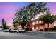 Condo exterior at dusk with parking, colorful buildings, and mature trees at 3675 41St S Way # K, St Petersburg, FL 33711
