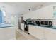 Kitchen with white cabinets, stainless steel appliances, and blue countertops at 3675 41St S Way # K, St Petersburg, FL 33711