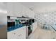Open kitchen with white cabinets, stainless steel appliances, and breakfast nook at 3675 41St S Way # K, St Petersburg, FL 33711