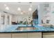 Open kitchen featuring stainless sink, quartz countertops, and views to the living room at 3675 41St S Way # K, St Petersburg, FL 33711