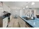 Bright kitchen features white cabinetry, stainless appliances, and blue countertops with eat-in dining at 3675 41St S Way # K, St Petersburg, FL 33711