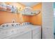 Bright laundry room with modern washer and dryer, built-in shelving, and storage at 3675 41St S Way # K, St Petersburg, FL 33711