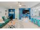 Living room with wood floors, TV, adjacent dining, and a kitchen bar with barstools at 3675 41St S Way # K, St Petersburg, FL 33711