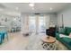 Bright living room with seating and view to the balcony and adjacent dining room at 3675 41St S Way # K, St Petersburg, FL 33711