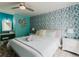 Comfortable main bedroom featuring blue accent wall, ceiling fan, and great lighting at 3675 41St S Way # K, St Petersburg, FL 33711
