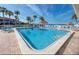 Sparkling community pool with lounge chairs, palm trees, and a gazebo, perfect for relaxation at 3675 41St S Way # K, St Petersburg, FL 33711