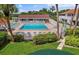 Large community pool and lounge area, lined with lush flowers and tropical palm trees at 3675 41St S Way # K, St Petersburg, FL 33711