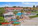 Community clubhouse featuring a large swimming pool, lounge chairs, and manicured landscaping near beach at 3675 41St S Way # K, St Petersburg, FL 33711