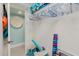 Well-organized storage room with beach equipment and a view to the turquoise bathroom at 3675 41St S Way # K, St Petersburg, FL 33711