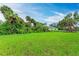 A beautiful backyard is surrounded by mature trees, offering plenty of privacy and a serene atmosphere at 3879 E Price Blvd, North Port, FL 34288