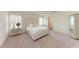 Bright bedroom featuring a luxurious bed, side table, and neutral decor at 3879 E Price Blvd, North Port, FL 34288