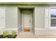 Inviting front entrance with a welcoming doormat and stylish shutters at 3879 E Price Blvd, North Port, FL 34288
