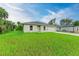 Inviting single-story home with a well-manicured lawn and a front-facing garage at 3879 E Price Blvd, North Port, FL 34288