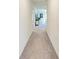 Clean hallway with neutral carpet leading to various rooms in the home at 3879 E Price Blvd, North Port, FL 34288