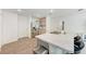 Modern kitchen with stainless steel refrigerator, gray cabinetry and a large island with barstool seating at 3879 E Price Blvd, North Port, FL 34288