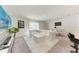Bright living room featuring a white leather sectional and open floor plan at 3879 E Price Blvd, North Port, FL 34288