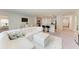 Open-concept living area with a white sectional sofa and modern decor at 3879 E Price Blvd, North Port, FL 34288