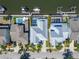 An aerial view displaying metal roofed home next to canal with boats and screened in pool at 426 Islebay Dr, Apollo Beach, FL 33572