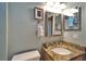 Powder blue bathroom with a granite vanity, sink, and framed mirror at 426 Islebay Dr, Apollo Beach, FL 33572
