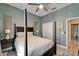 Bedroom with ceiling fan, neutral walls, four poster bed and wood-look floors at 426 Islebay Dr, Apollo Beach, FL 33572