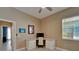Neutral bedroom with ceiling fan, a desk next to a window, and light gray flooring at 426 Islebay Dr, Apollo Beach, FL 33572