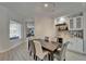 Elegant dining room with bar, modern lighting, and neutral tones at 426 Islebay Dr, Apollo Beach, FL 33572