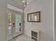 Bright entryway with a stylish light fixture, mirror, and console table at 426 Islebay Dr, Apollo Beach, FL 33572