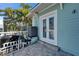 Exterior view of light blue siding, white trim and french doors opening up onto a rear patio at 426 Islebay Dr, Apollo Beach, FL 33572