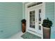 Elegant double front doors flanked by potted plants and a welcome mat at 426 Islebay Dr, Apollo Beach, FL 33572